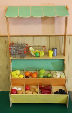 Küçük meyve ile lots-in balıkçı olmak gibi yapıp çocuk oynamak için plastik meyve standı