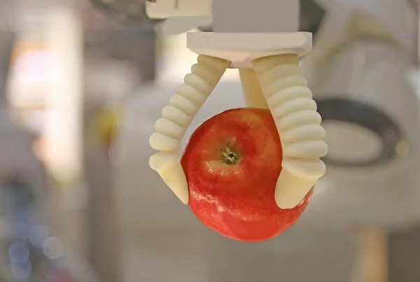 Robot Mechanical Arm Grabs Red Apple — Stock Photo, Image