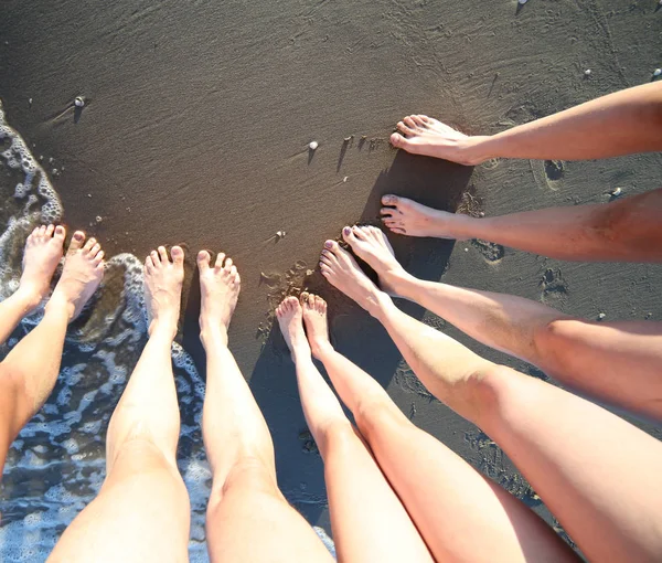 ten barefoot feet of a family of five with mum dad and three children