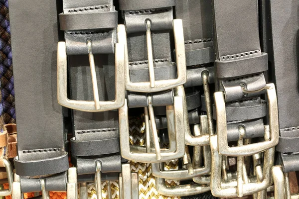 Many metallic buckles of leather belts for sale in the leather goods shop