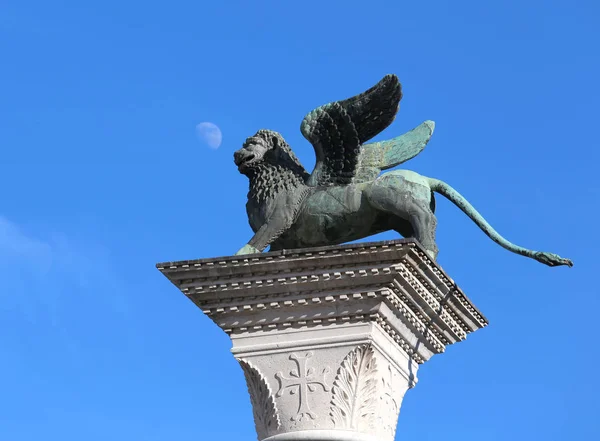 The winged lion symbol of of the city of VENICE with the background of the blue sky and a bit of the moon