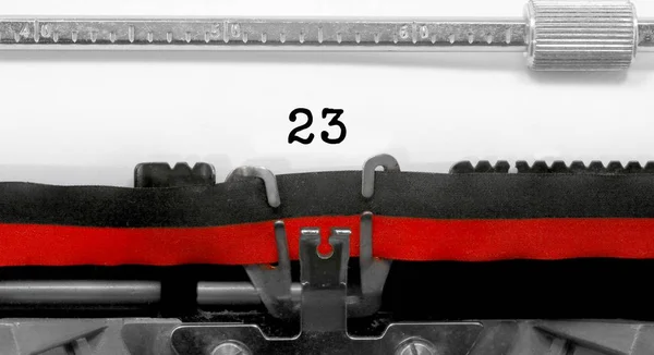 23 Number text written by an old typewriter on white sheet