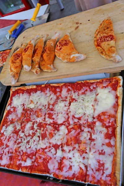 Food stall on the street with pizza sales Margherita and stuffed panzerotti