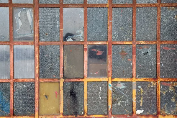 old glass door of a workshop with glasses in the form of rectangles