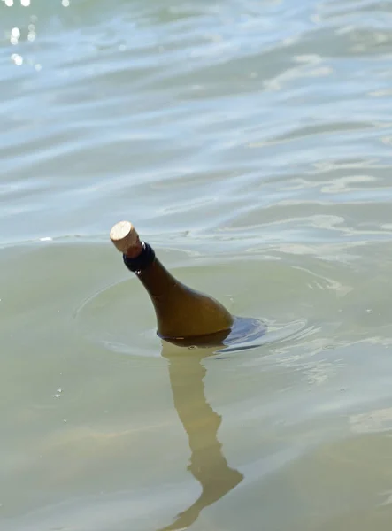 bottle with secret message floats on the water of the sea