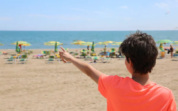 少年夏のビーチから海を示しています — ストック写真