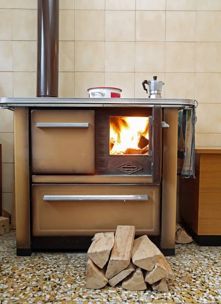 stove lit in a mountain cabin with a moka pot on top