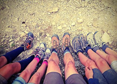 ten trekking shoes of five people with vintage effect clipart