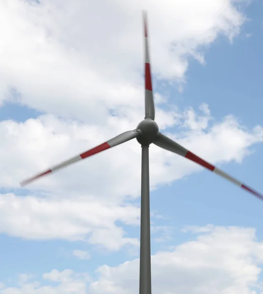movement of the large blades of the wind turbine that uses the wind to produce electricity