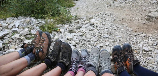 ten lightweight boots of a family of five person in mountains