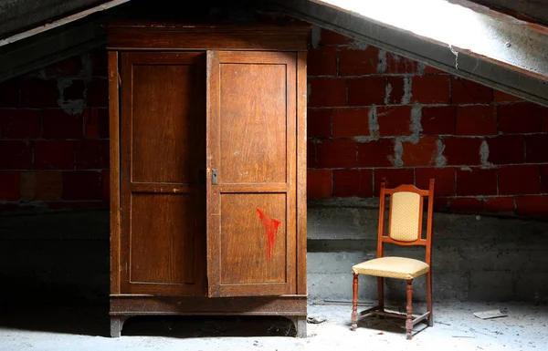 abandoned house with wooden closet and old chair