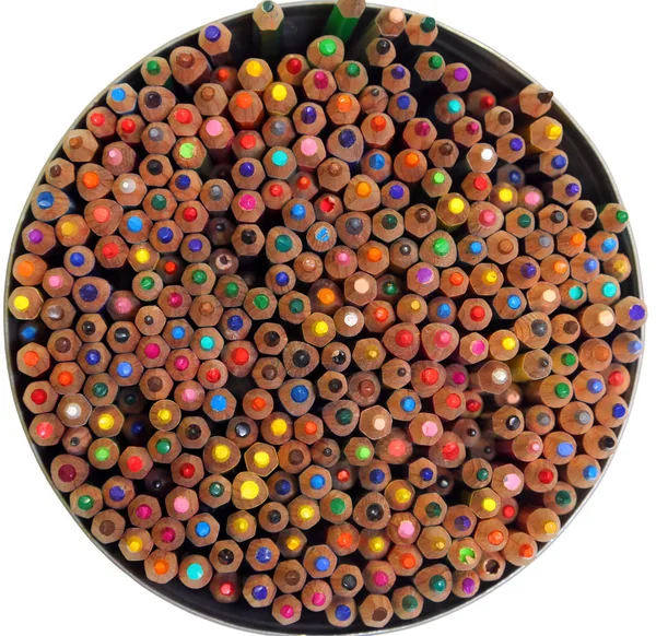 circle of colorful wooden crayons of various colors on white background