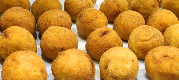 rice balls are the typical specialties of Southern Italy fried in hot oil