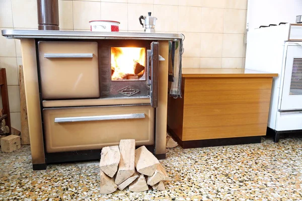 wood-burning stove in the kitchen with a moka pot on the fire