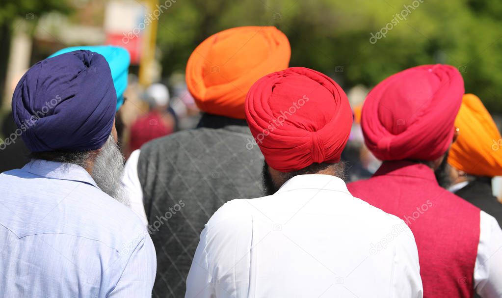 Sikh men wear colorful turbans during a religious event