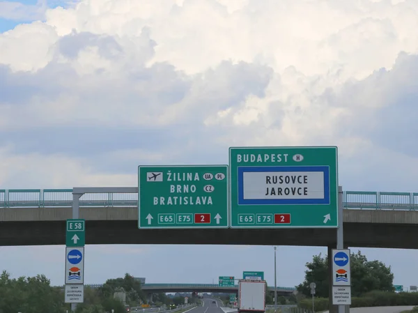 large highway sign on the border between Hungary and Czech Repoublic with directions to go to Budapest or Bratislava City or Brno in Europe