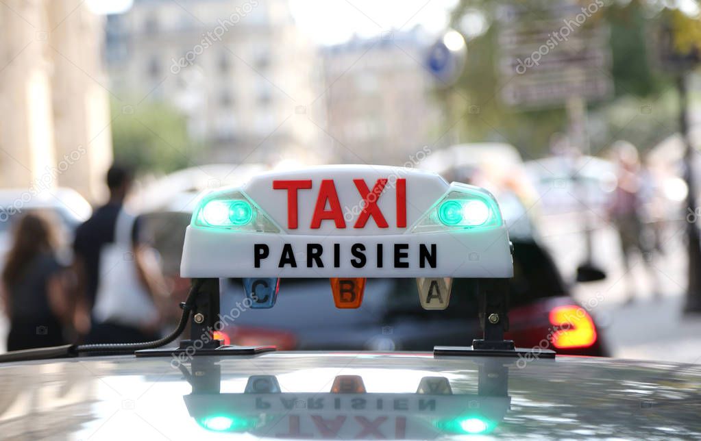 French taxi text with lights in the capital of France in Europe