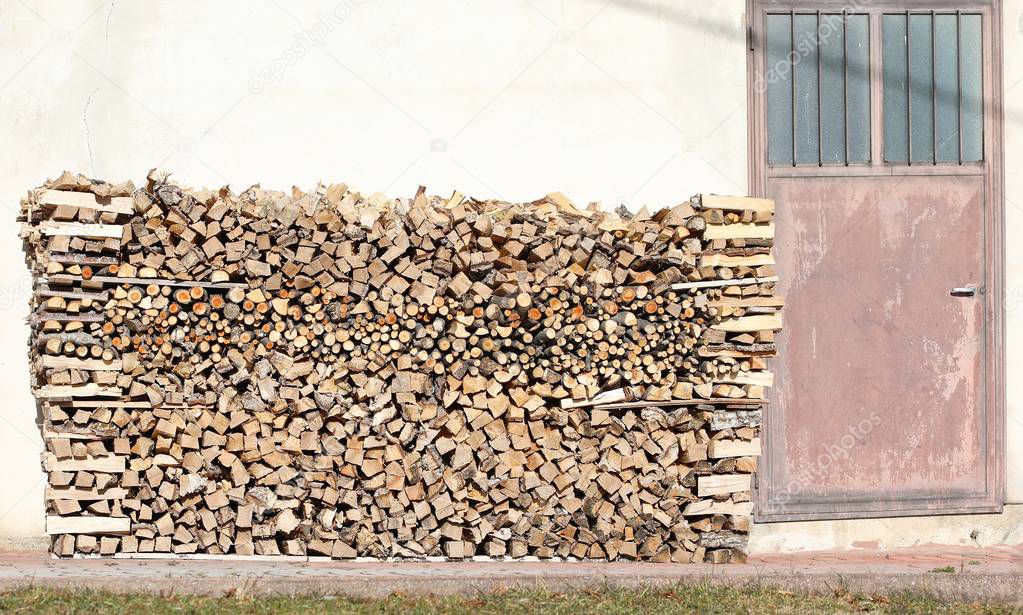 large woodshed tidy with many pieces of wood for the winter
