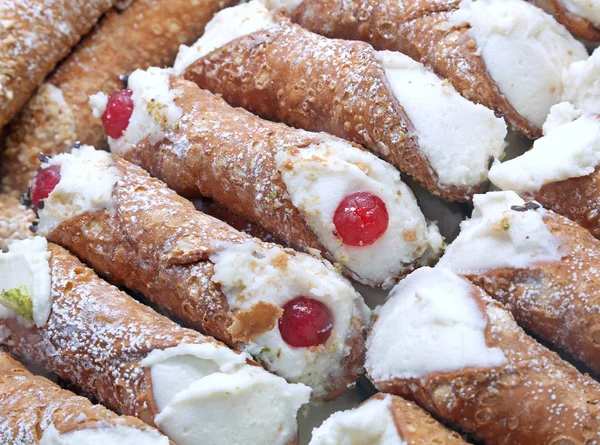 background of typical sweet food of Italy called CANNOLO SICILIANO with red candied cherries and cheese