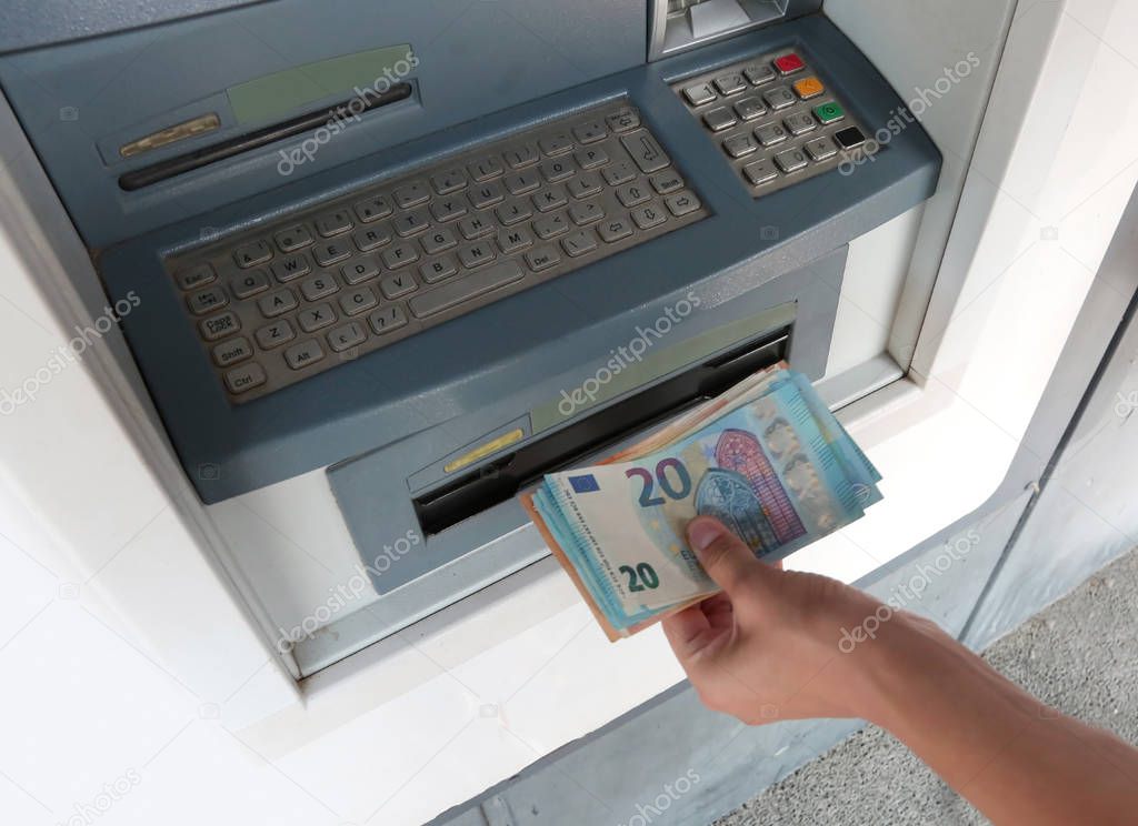 atm machine and european money banknotes with an hand