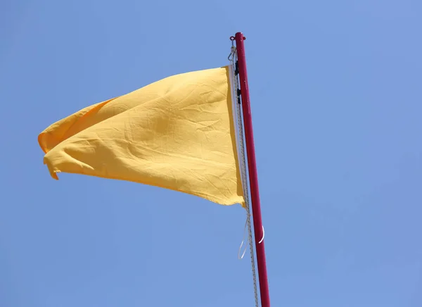 Big Yellow Flag Waving Blue Sky Warning — Stock Photo, Image