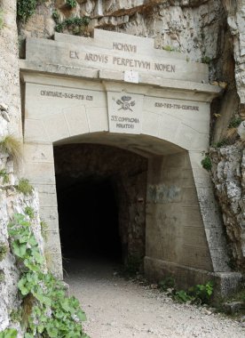 First tunnel of the Tunnel Road on Mount Pasubio with the inscription of the army group that with sacrifice built the tunnels during the First World War in Italy in Vicenza Province clipart