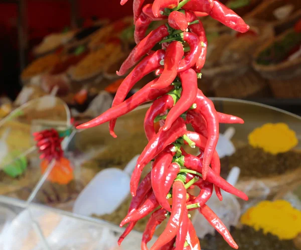 many spicy red chillies for sale in the outdoor market stall