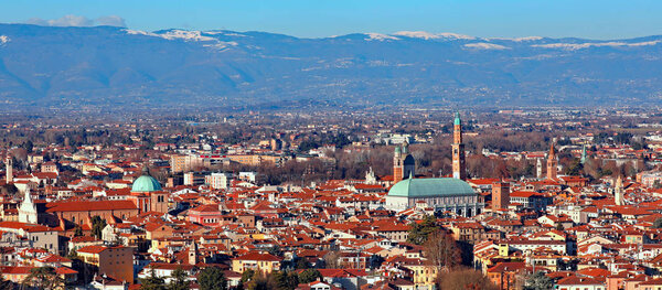 Wide panorama of the city of Vicenza in the Veneto Region in Italy and the famous monument called Basilica Palladiana with the tall Clock Tower