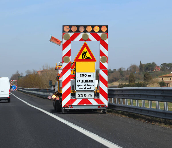 Work in progess in the italian road the text meas Reduce Speed