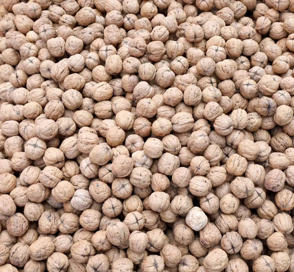 Fundo de muitas nozes cultivadas com técnicas orgânicas sem ch — Fotografia de Stock