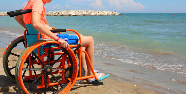 young boy on the orange wheelchair
