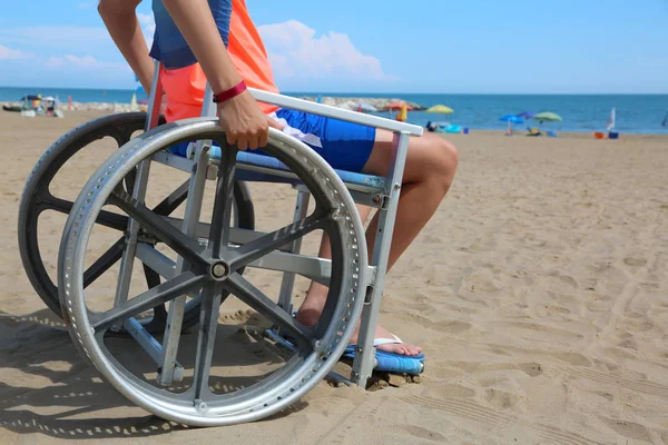 Boy on the wheelchair on the beach — Stock Photo, Image