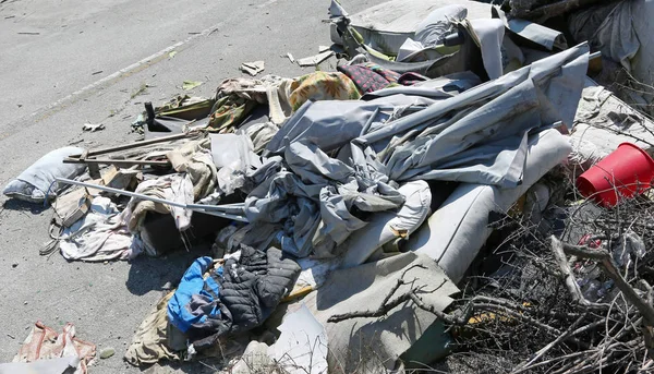 rags and garbage in a homeless camp