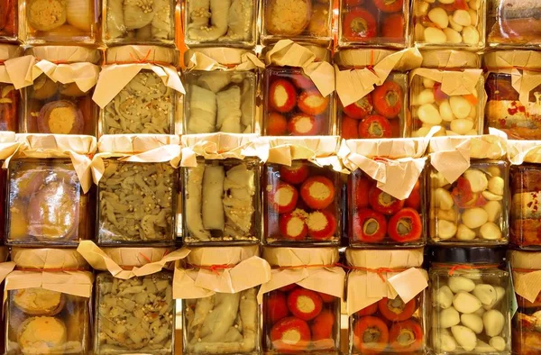 Jars with preserved food for sale at local market — Stock Photo, Image