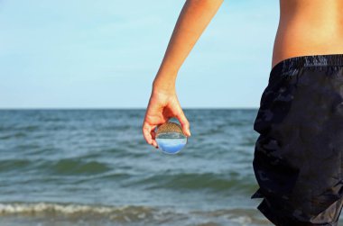 young boy with crystal glass on the hand