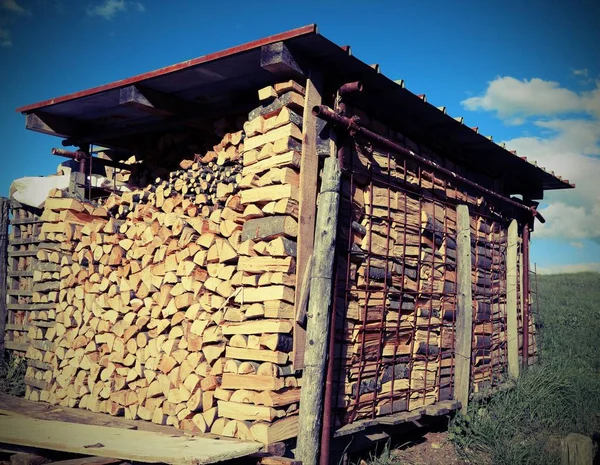 Logs of a woodpile in the Woodshed with old toned effect — Stock Photo, Image