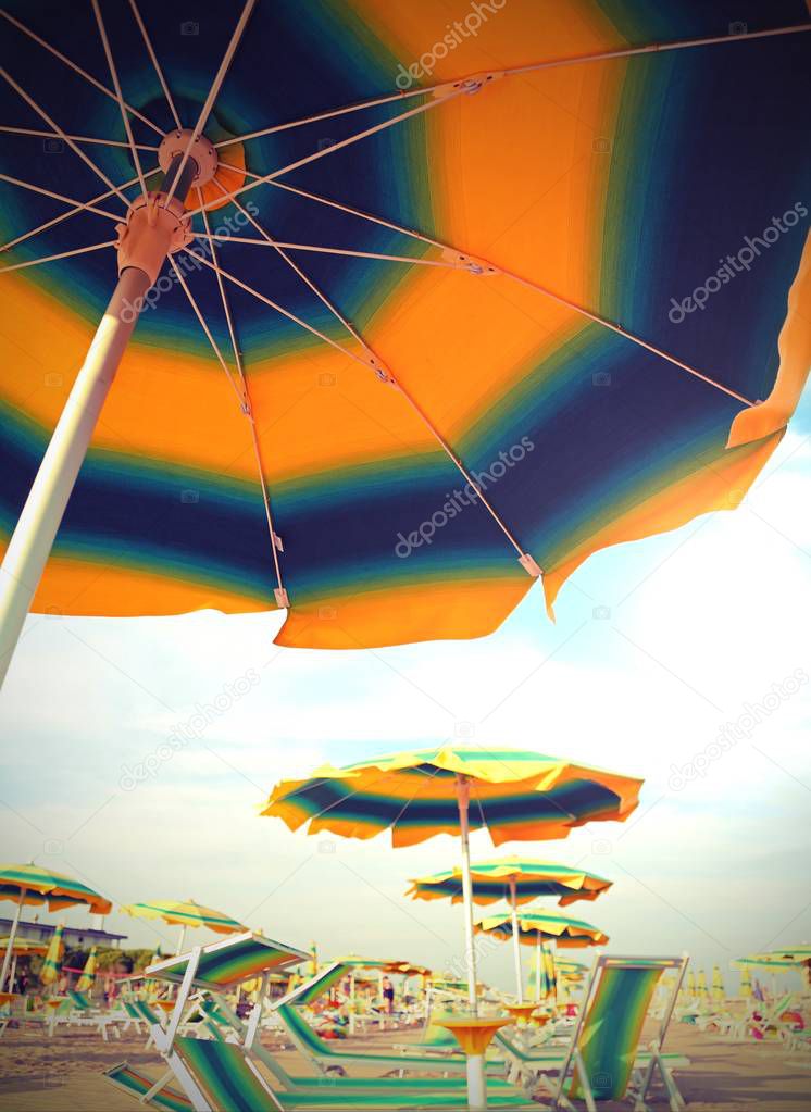 parasol on the beach in summer without people with toned old eff