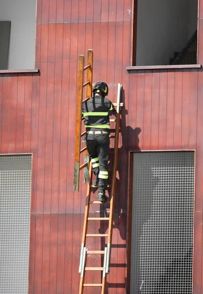 Rescue exercises with the ladder and fireman with helmet — Stock Photo, Image