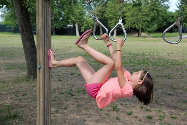 Menina faz um exercício de ginástica em um caminho de saúde — Fotografia de Stock