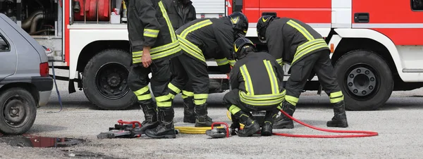 Group of firefighters in action — Stock Photo, Image