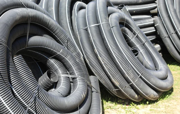 Construction site with corrugated pipes for laying fiber optics — Stock Photo, Image