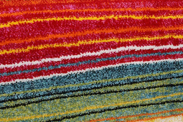 Chenille rug with colorful lines of contrasting fabric — Stockfoto