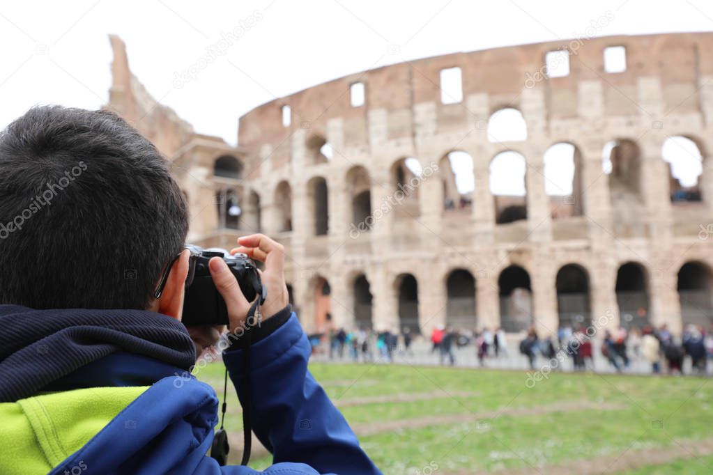 photographer taking a picture of the Roman Colosseum amphitheate