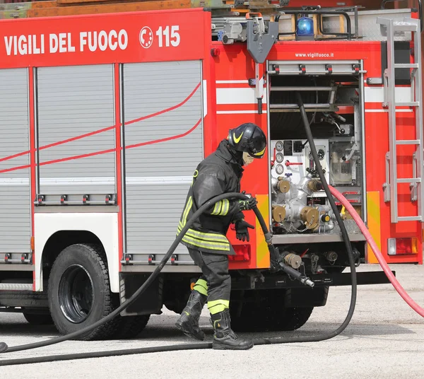 Rome, RM, Italy - May 23, 2019: fireman with helmet and the fire — Stock Photo, Image