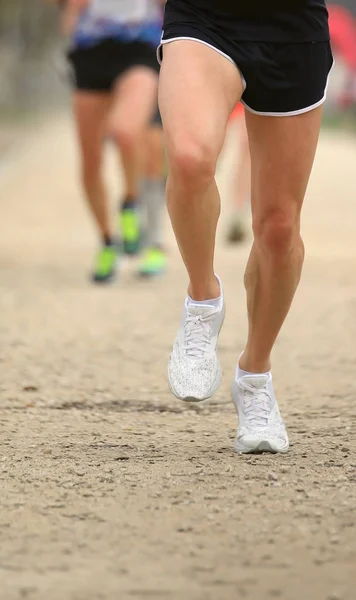 Piernas de un atleta que participa en una carrera a campo traviesa — Foto de Stock