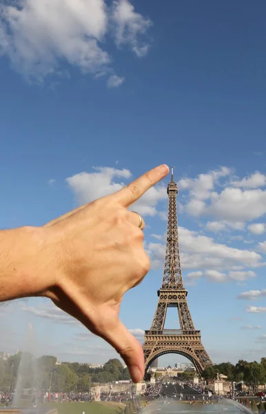 Hand that jokingly measures the Eiffel Tower with the span — Stock Photo, Image