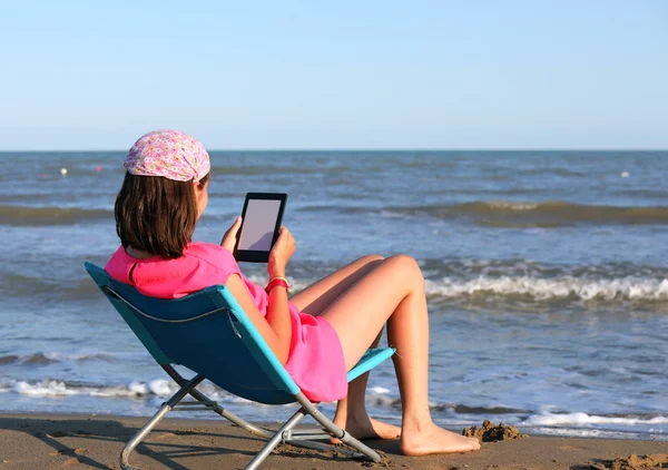 Little girl reads the ebook in summer — Stock Photo, Image
