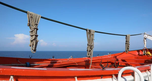 Спасательная шлюпка с веревками в круизном лайнере у океана — стоковое фото