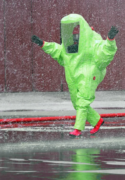 Fireman wears a protective suit to extinguish a fire caused by t — Stock Photo, Image