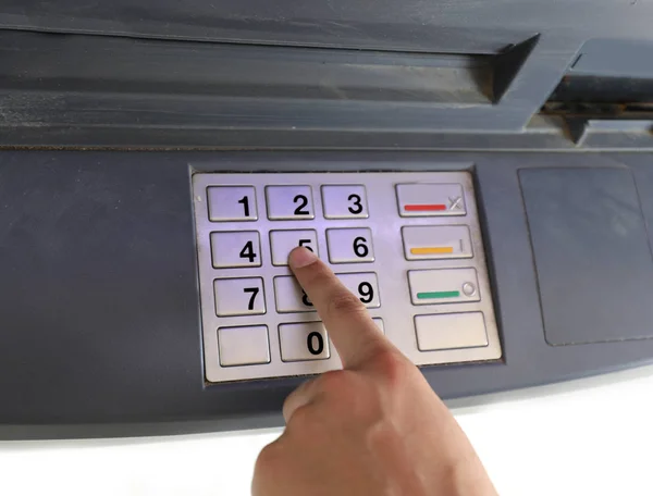 hand insert the secret code on the ATM